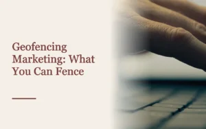 Cover titled Geofencing Marketing beside a hand held above a laptop keyboard