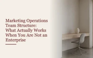 Headline cover for marketing operations team structure beside an empty modern studio desk